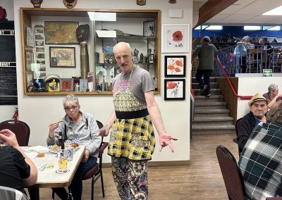Man in apron serving dinner at Legion